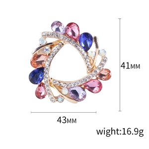 Vintage crystal glass brooch with colorful rhinestones in golden hollow spiral design