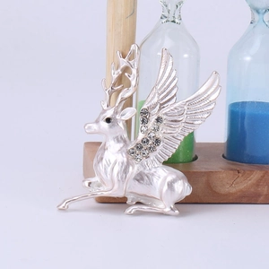 Detailed view of silver flying deer brooch with sparkling rhinestones and brushed metal finish