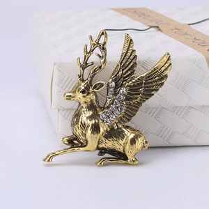 Detailed macro of golden winged reindeer brooch with sparkling crystal rhinestones inlay