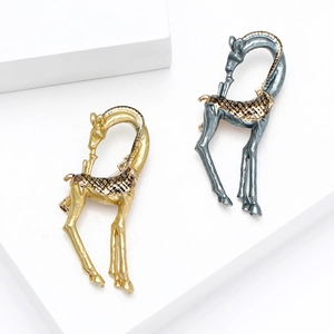 Elegant giraffe enamel brooches in gold and silver finish on a clean white display