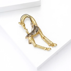 Detailed back view of a golden giraffe brooch showing the metallic texture and secure pin clasp