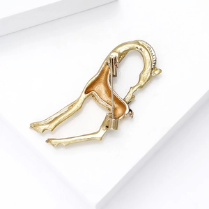 Golden giraffe brooch back detail with secure safety pin clasp and textured alloy finish