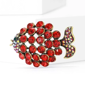 Elegant vintage gold fish brooch with red crystals and green gemstone eyes