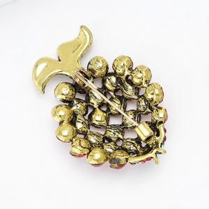 Detailed back view of gold fish brooch showing secure pin clasp and metal structure