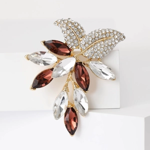 Detailed view of luxury crystal floral brooch with amber and clear marquise stones