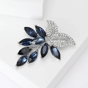 Elegant leaf brooch with deep blue marquise crystals and sparkling white rhinestones on silver base