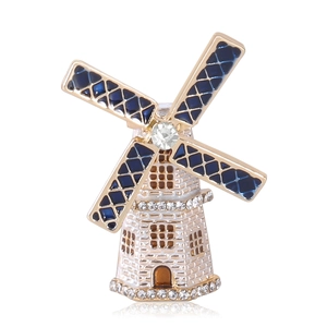 Elegante spilla a mulino dorata con smalto blu scuro e strass brillanti per donna
