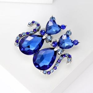Close-up of cat brooch with dark blue water-drop crystals and silver alloy finish