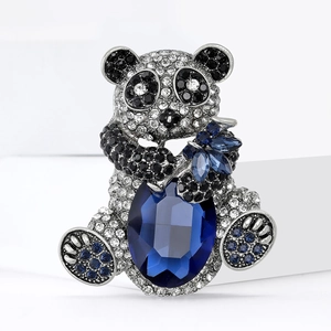 Exquisite panda brooch featuring silver metal, clear crystals, and a large blue gemstone