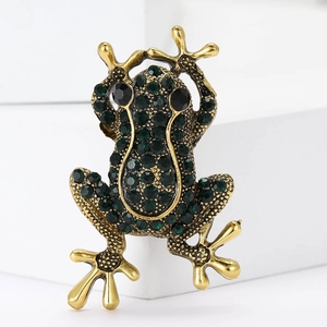 Broche grenouille vintage dorée avec strass verts étincelants sur blocs blancs