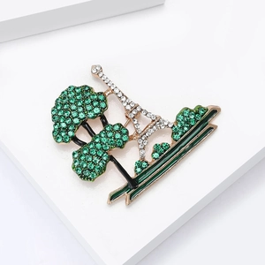 Eiffel Tower and green tree brooch with sparkling rhinestones on golden alloy