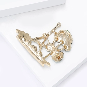 Detailed back view of a golden tree brooch showing the secure safety pin clasp and texture