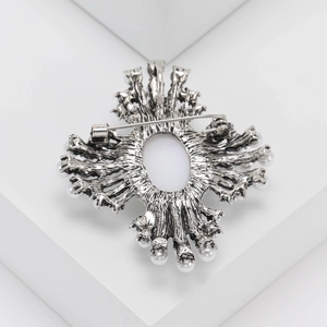 Detailed back view of vintage silver brooch with pearls and secure safety pin clasp