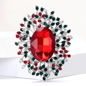 Macro shot of a vintage alloy brooch with red oval crystal and multicolor rhinestones