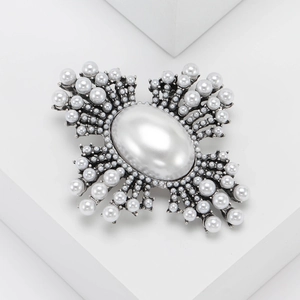Retro vintage pearl brooch with large oval center and antique silver finish on a pedestal