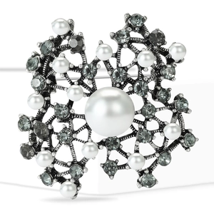 Vintage flower pearl brooch with grey crystals and antique silver finish on white background