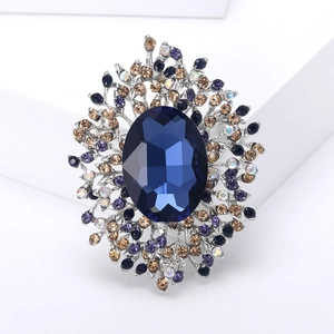 Elegant silver alloy brooch with large deep blue crystal and colorful rhinestones