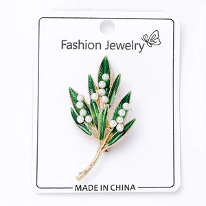 Detail of Lily of the Valley brooch with green enamel leaves and white pearls