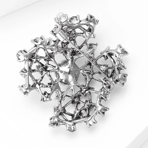 Detailed back view of vintage silver brooch with secure pin clasp and pearl accents