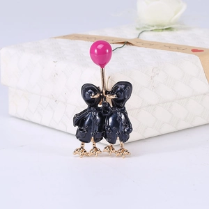 Detail of creative enamel duck couple brooch with pink balloon on elegant gift box