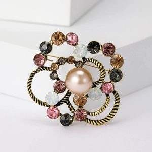 Detailed macro of vintage flower brooch with champagne pearl and multicolored crystals