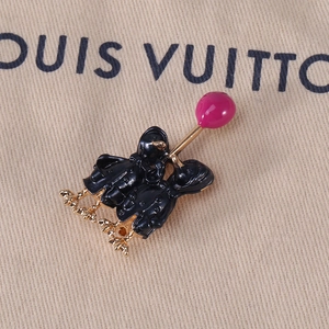 Close-up of enamel duck brooch with balloon on beige textured fabric background