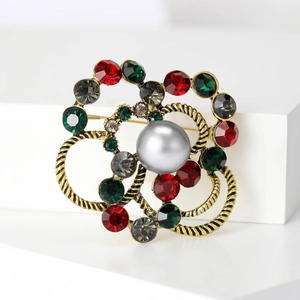 Macro detail of vintage floral brooch featuring twisted gold wire and multicolor rhinestones