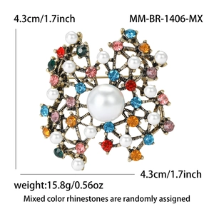Vintage style brooch with colorful rhinestones and pearls on white background