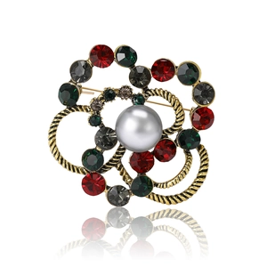 Vintage floral brooch with grey pearl and colorful rhinestones on a golden frame