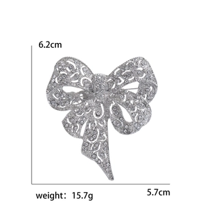 Vintage silver rhinestone bow brooch with detailed size dimensions 6.2cm by 5.7cm