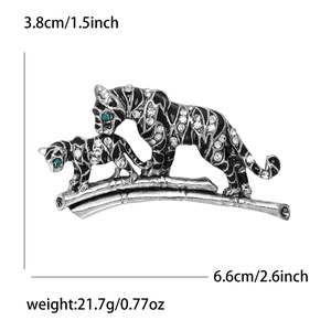 Detail showing dimension 6.6x3.8cm of silver tiger brooch with crystals and green eyes