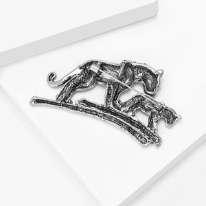 Detailed back view of vintage tiger brooch showing sturdy safety pin and antique texture