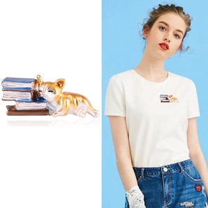 Creative enamel brooch featuring a cute lazy cat sleeping on books for clothing accessory