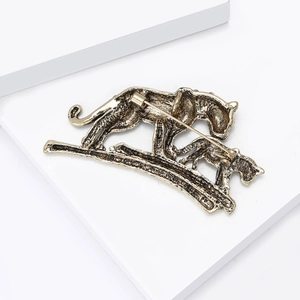 Macro shot of tiger brooch back structure with durable safety pin and golden alloy finish