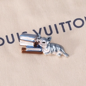 Detailed close-up of a cute lazy cat sleeping on blue books enamel brooch pin