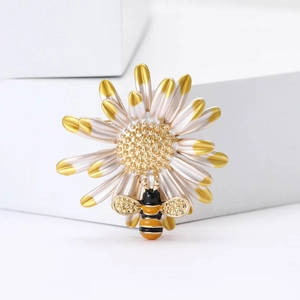 Exquisite daisy and bee brooch with enamel finish and sparkling crystal accents
