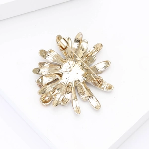 Detailed back view of the golden flower brooch showing the secure pin clasp and metal finish