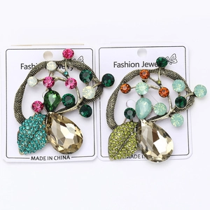 Detail of vintage bronze tree brooches with multi-color rhinestones and crystals