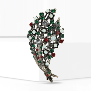 Detailed macro view of vintage bouquet brooch with colorful rhinestones and bronze base
