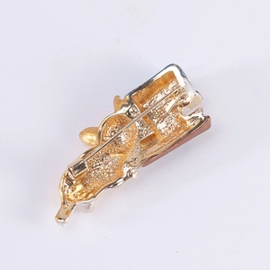Back view of cute lazy cat brooch in gold metal with safety pin and enamel details
