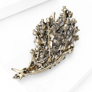 Vintage floral rhinestone brooch in antique gold finish showing back pin detail