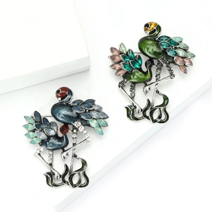 Elegant vintage flamingo brooch set with colorful rhinestones and enamel on white platform
