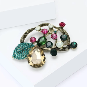 Macro detail of vintage bronze brooch with champagne crystal and colorful stones
