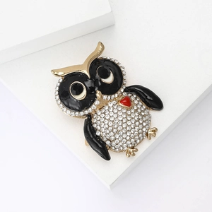 Sparkling crystal owl brooch in golden alloy with black enamel and red heart detail