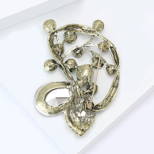 Detailed back view of vintage bronze brooch showing pin clasp and crystal drop
