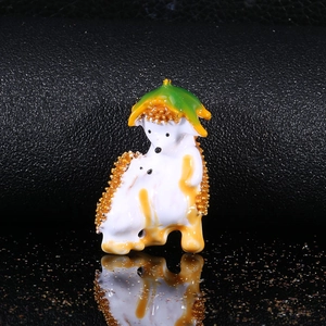 Detail of cute hedgehog enamel brooch with white finish and golden textured back