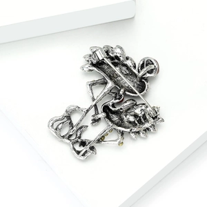 Detail view of the silver vintage flamingo brooch back with secure safety pin and lock