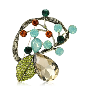 Vintage style floral branch brooch with multi-colored crystals and champagne teardrop stone