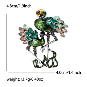 Vintage green enamel double crane brooch with colorful rhinestones on white background