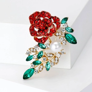 Elegant rose crystal brooch with red rhinestones, green gems and a large white pearl